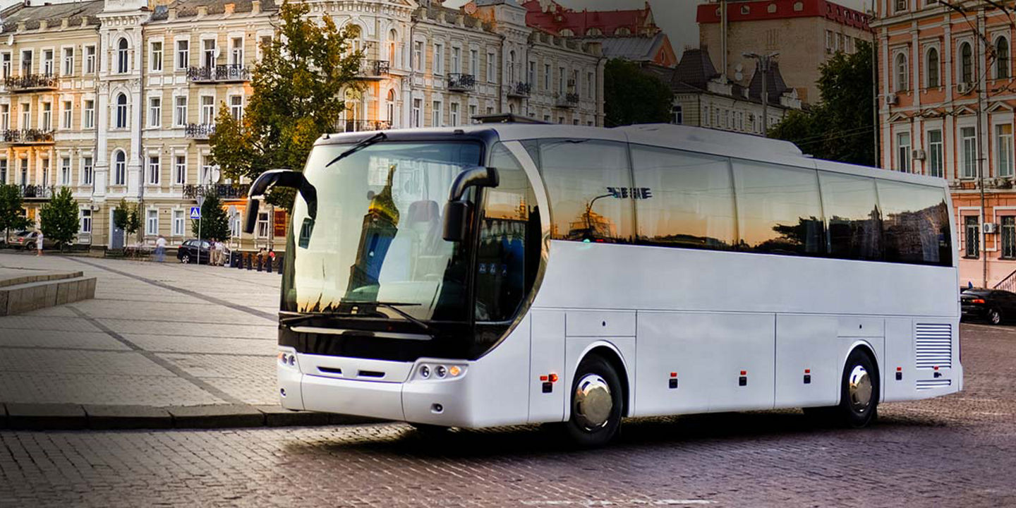 This image shows a bird's-eye view of a coach bus with Bridgestone coach tyres driving on the highway.