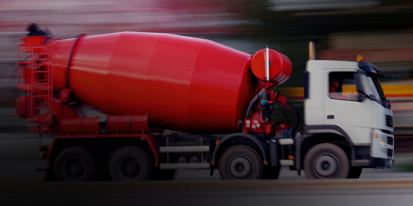 This image shows a cement truck with Bridgestone mild on/off road tyres driving on a highway to a worksite.