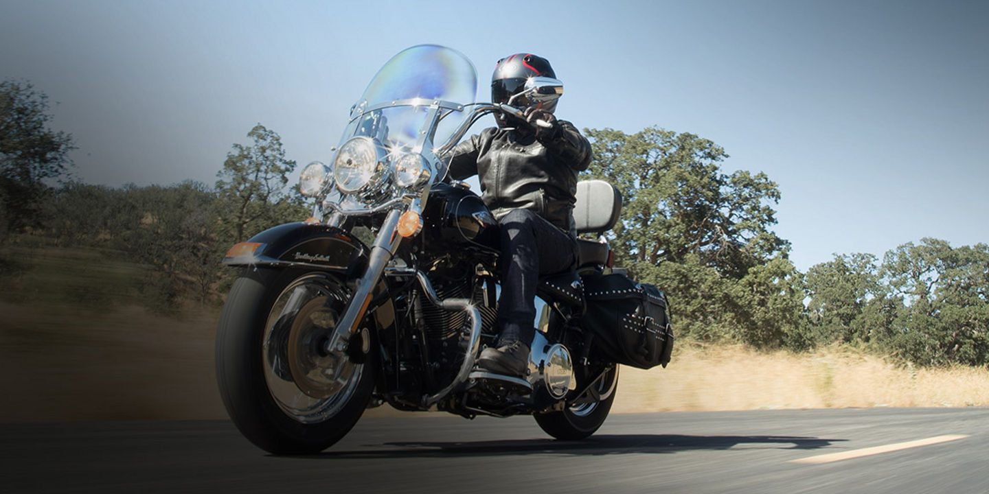 This image shows a motorcyclist driving on a regional road on a bike with custom Bridgestone motorcycle tyres.