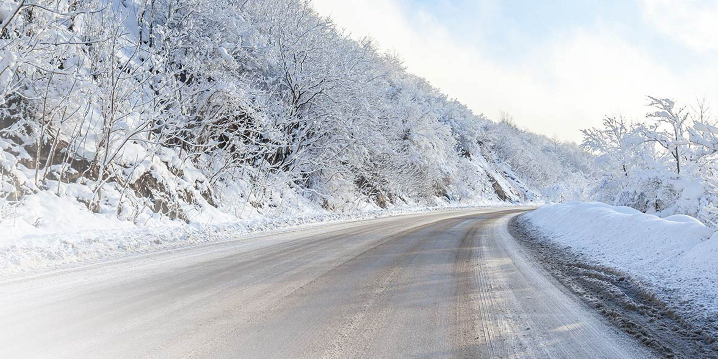 This image shows a winter road covered in snow with tracks from Bridgestone winter truck tyres.