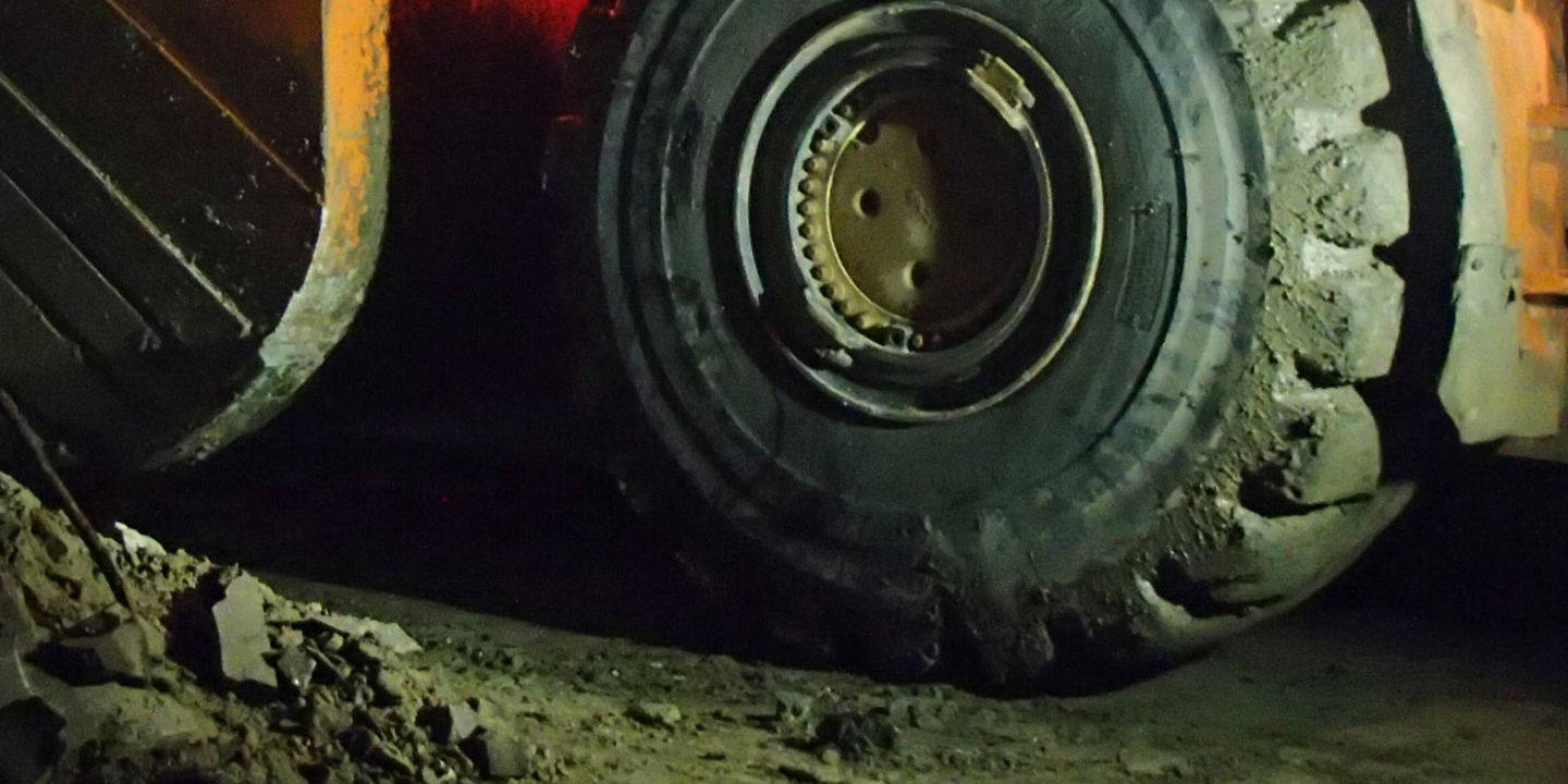 A large loader truck working in an underground mine