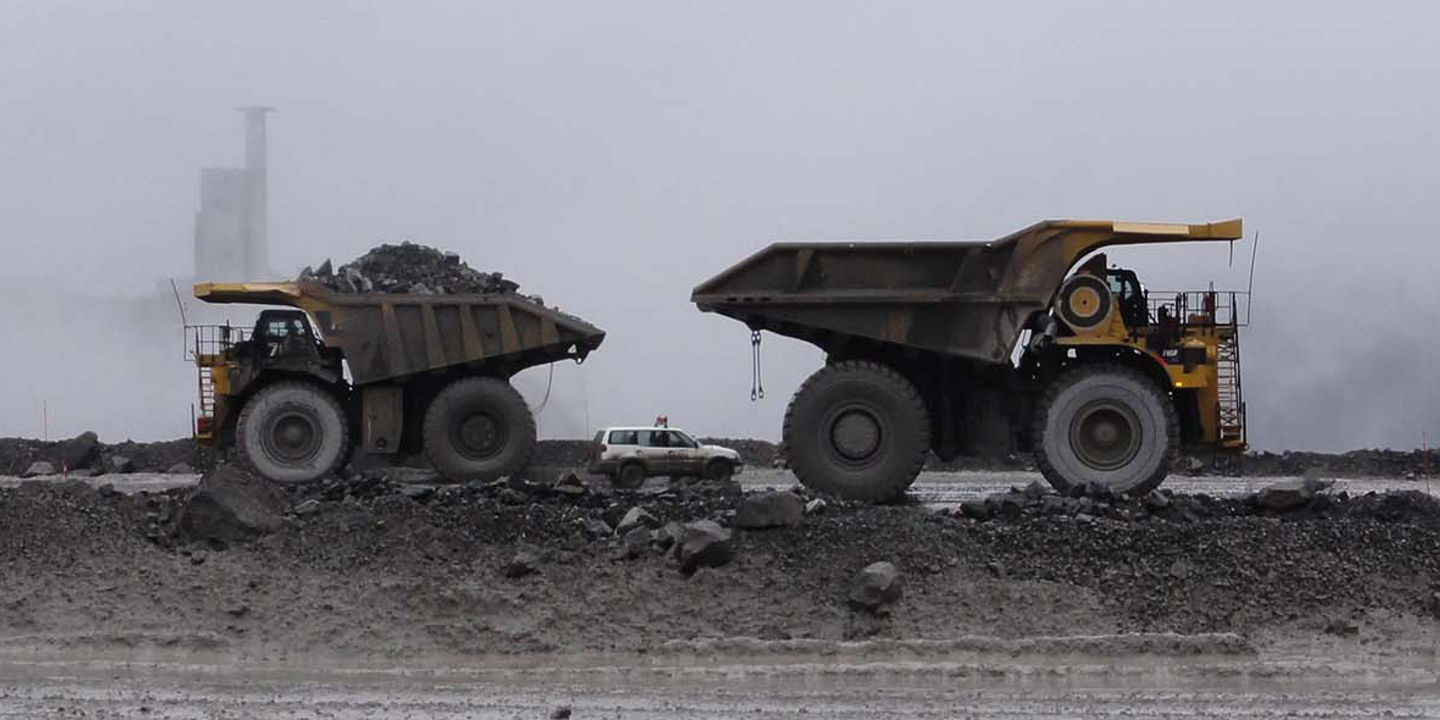 Four off-the-road vehicles equipped with Bridgestone tyres working in an open pit mine