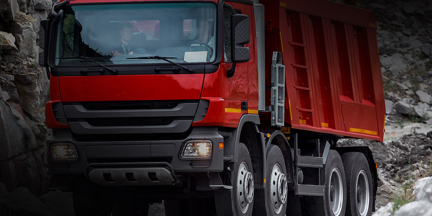 This image shows the front of a truck on a worksite with Bridgestone severe on/off road tyres.