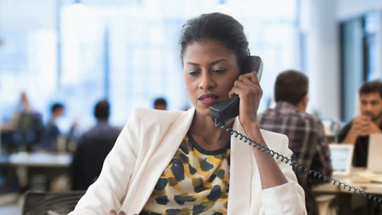 Businesswoman talking on telephone in office