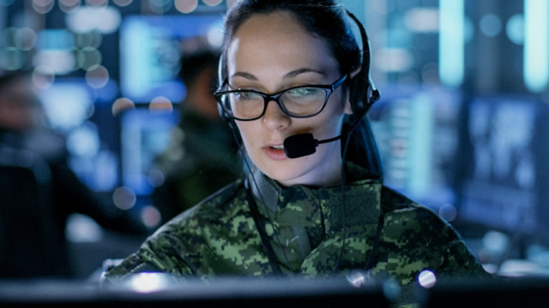 Close up shot of female army officer using computer