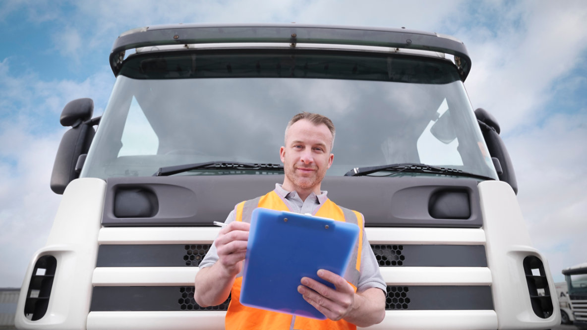 Truck driver checking notes