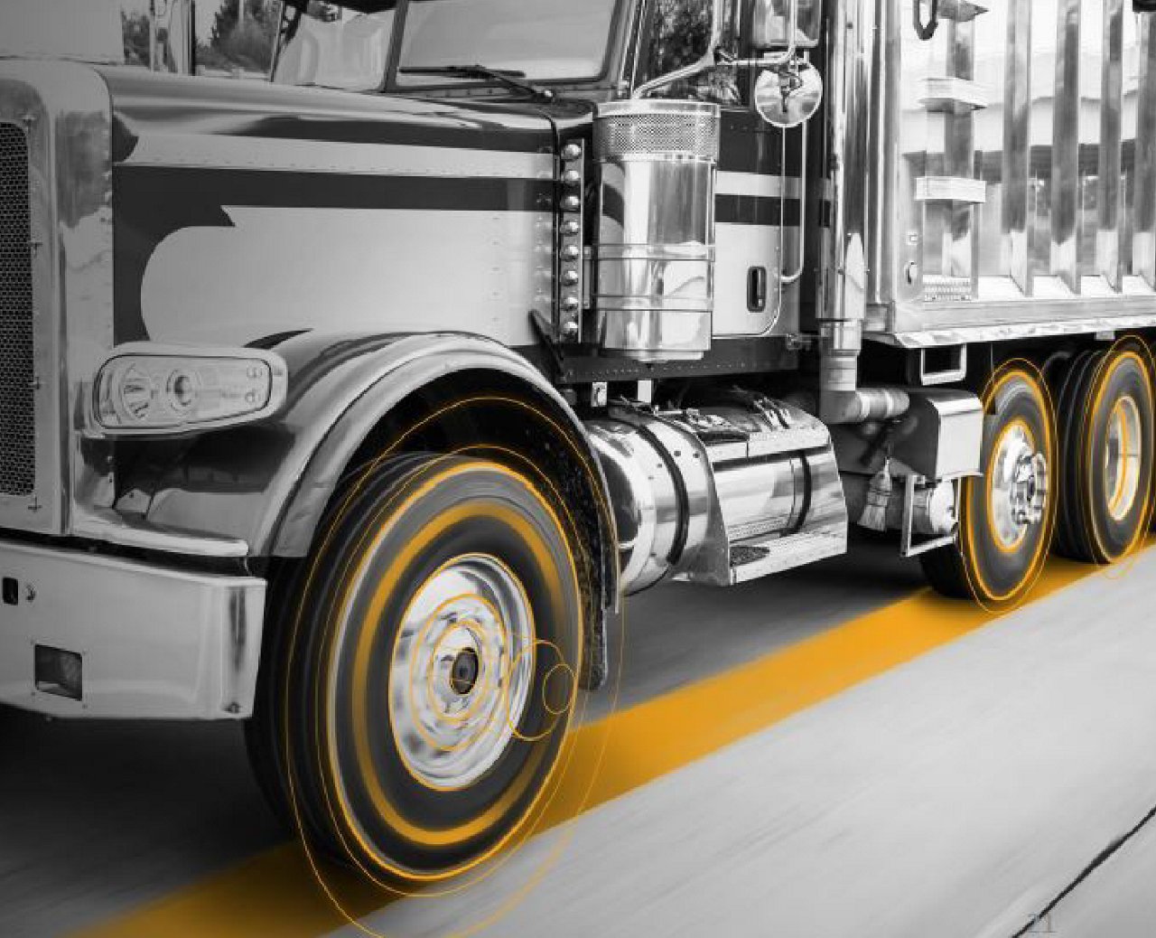 Commercial truck on road with yellow circles highlighting wheel motion; urban background visible.