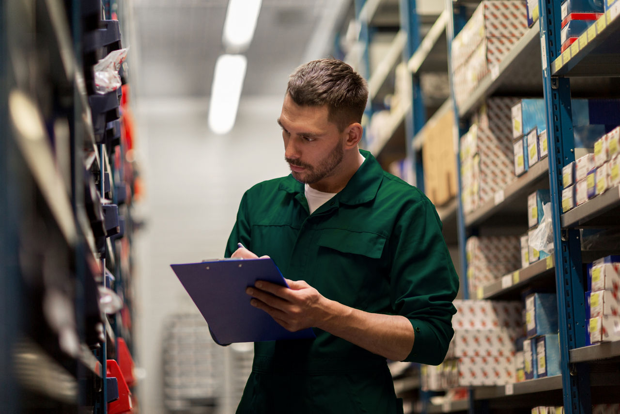 car service, repair, maintenance and people concept - auto mechanic man or smith writing to clipboard at workshop or warehouse; Shutterstock ID 506011774; purchase_order: sito; job: ; client: ; other: 
