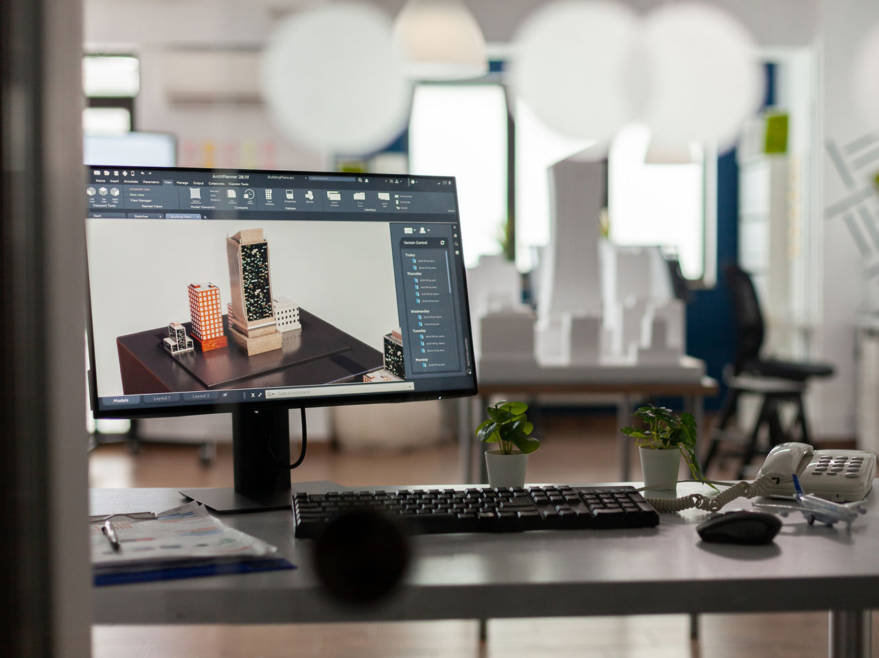 Closeup of modern architect desk with workstation showing 3d blueprints of architectural building complex. Desktop screen showing model of urban planning architecture construction plan.; Shutterstock ID 2100748765; purchase_order: sito; job: ; client: ; other: 