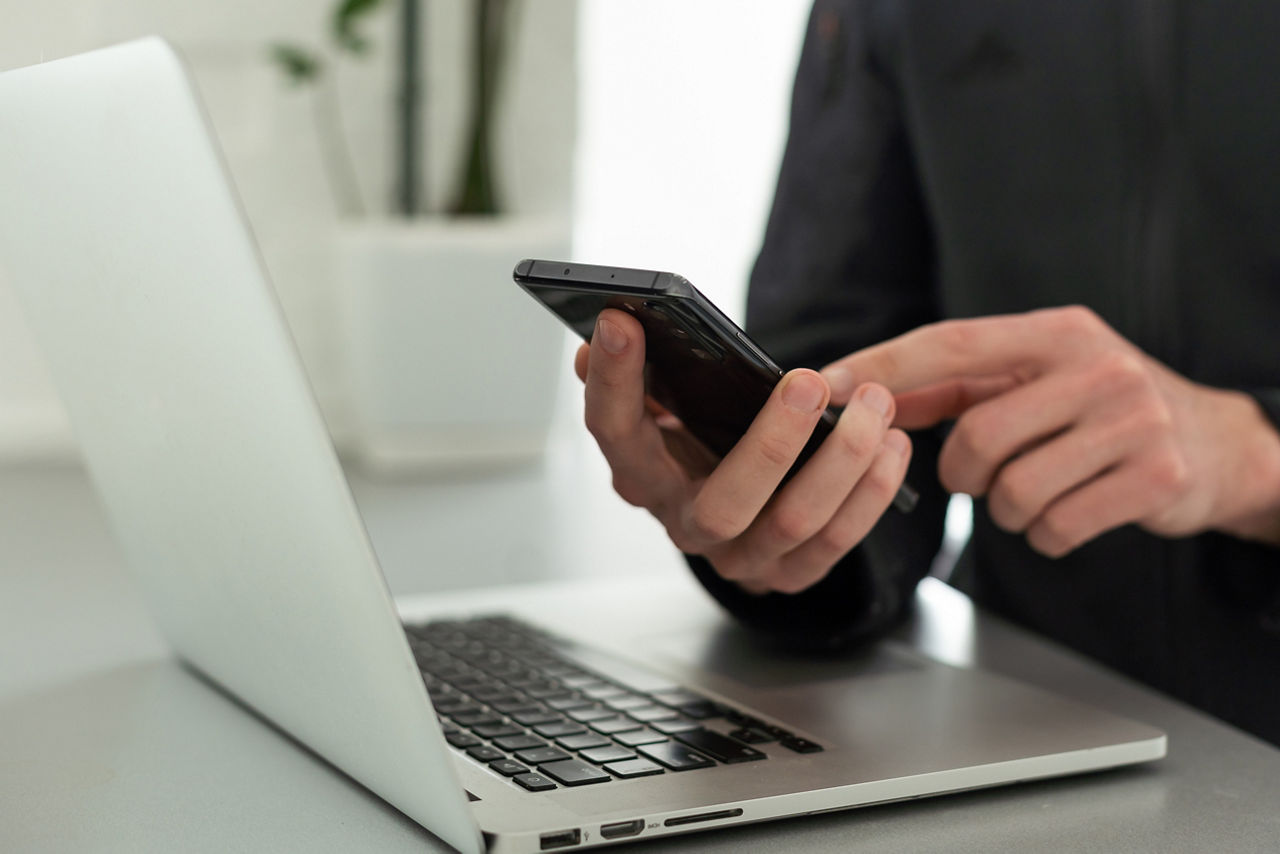 Businessman working with laptop, smartphone in hand. computer on the desk. Business concept.; Shutterstock ID 2302633177; purchase_order: sito; job: ; client: ; other: 