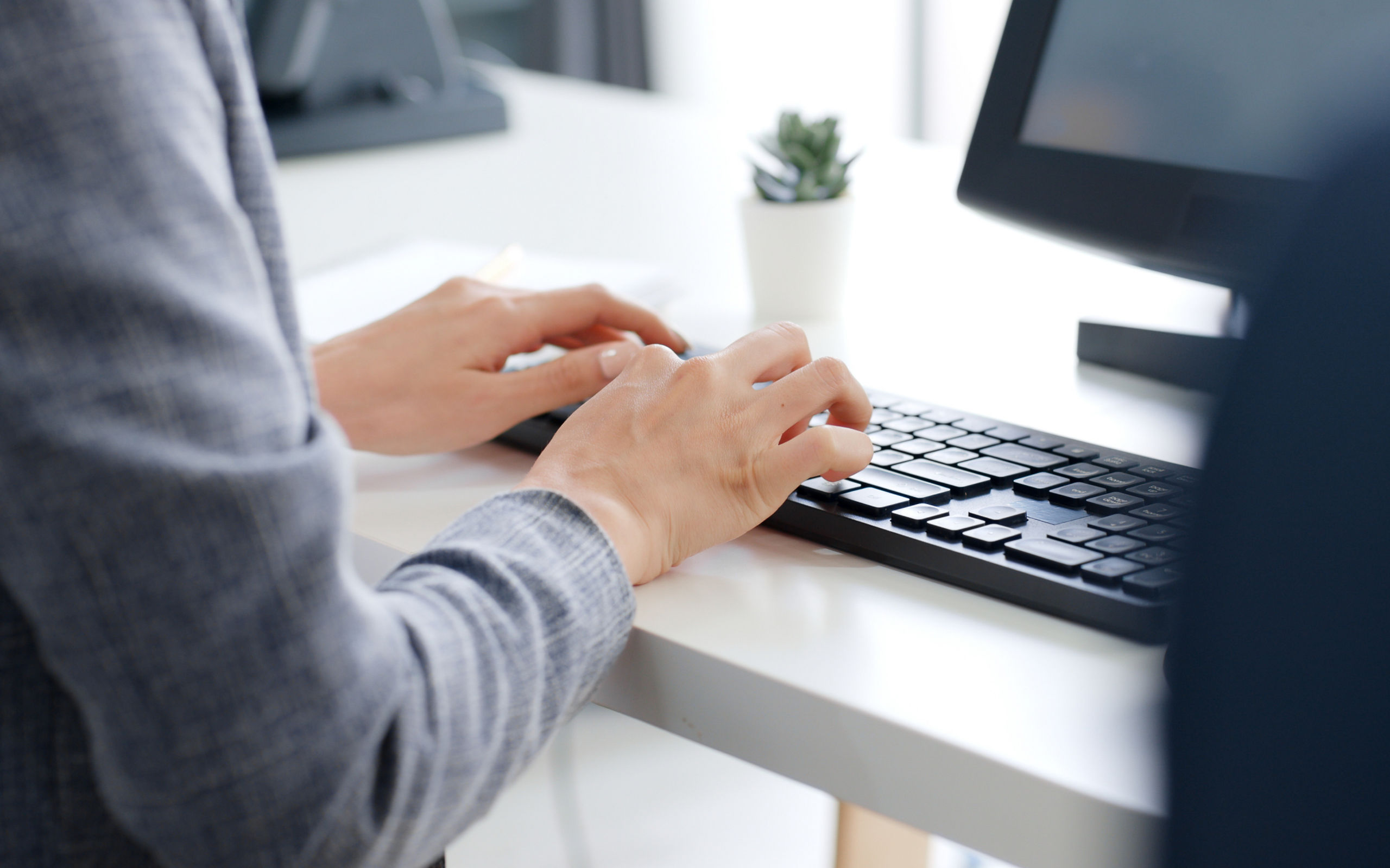 Closeup business people hands typing on keyboard computer desktop for using internet, searching data, working, writing email.