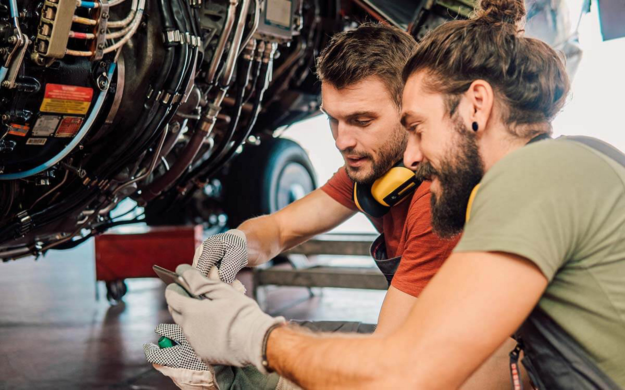 Zwei Arbeiter schauen auf ein Handy