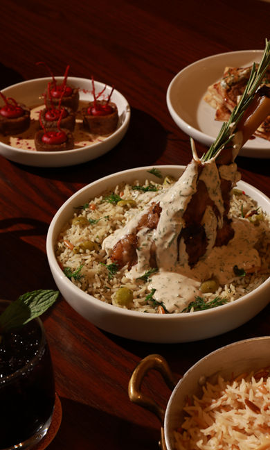 Slow-cooked lamb shank served over rice at Somewhere Diriyah.