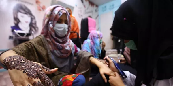 Una mujer adornando sus manos con Henna en Pakistán. Foto: EFE.