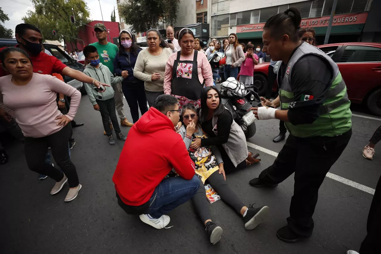 Personas permanecen en las calles después de activarse la alerta sísmica en la Ciudad de México. EFE