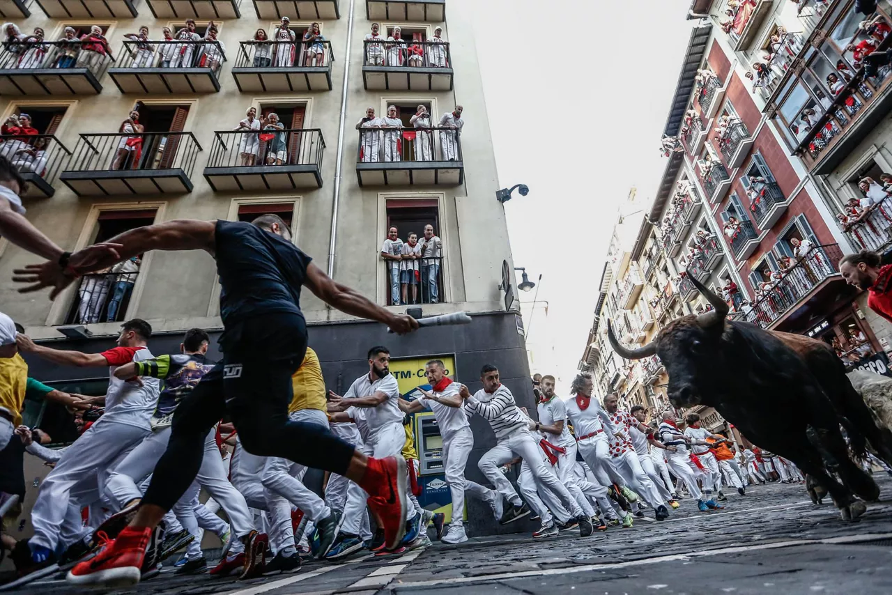 Un mozo corre delante de uno de los toros de la ganadería Fuente Ymbro. Foto: EFE