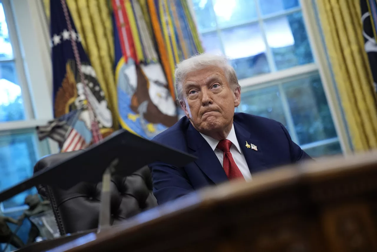 nited States President DONALD J TRUMP makes a statement as he displays a signed Executive Order in the Oval Office of the White House in Washington, D.C.
