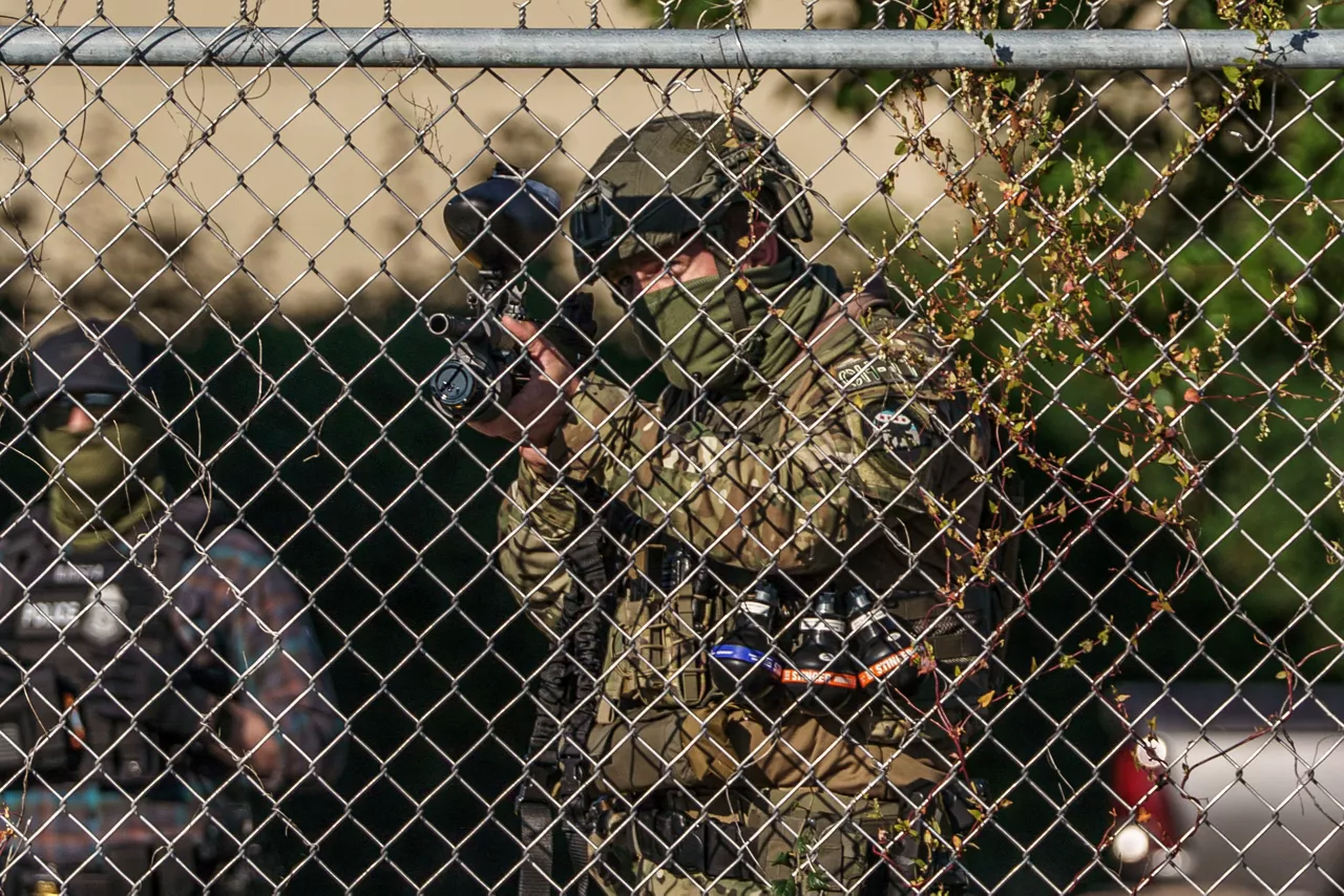 US federal agent fires a pepper ball gun at protesters during a demonstration against US' immigration policy and forced deportations near the Broadview ICE facility. 