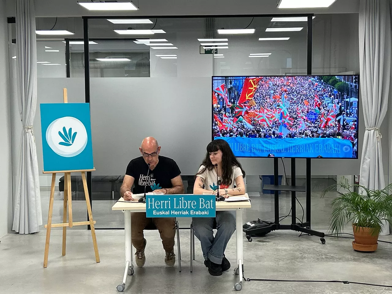 El portavoz de Gure Esku, Josu Etxaburu, y la responsable de comunicación, June Romatet, en rueda de prensa en San Sebastián.