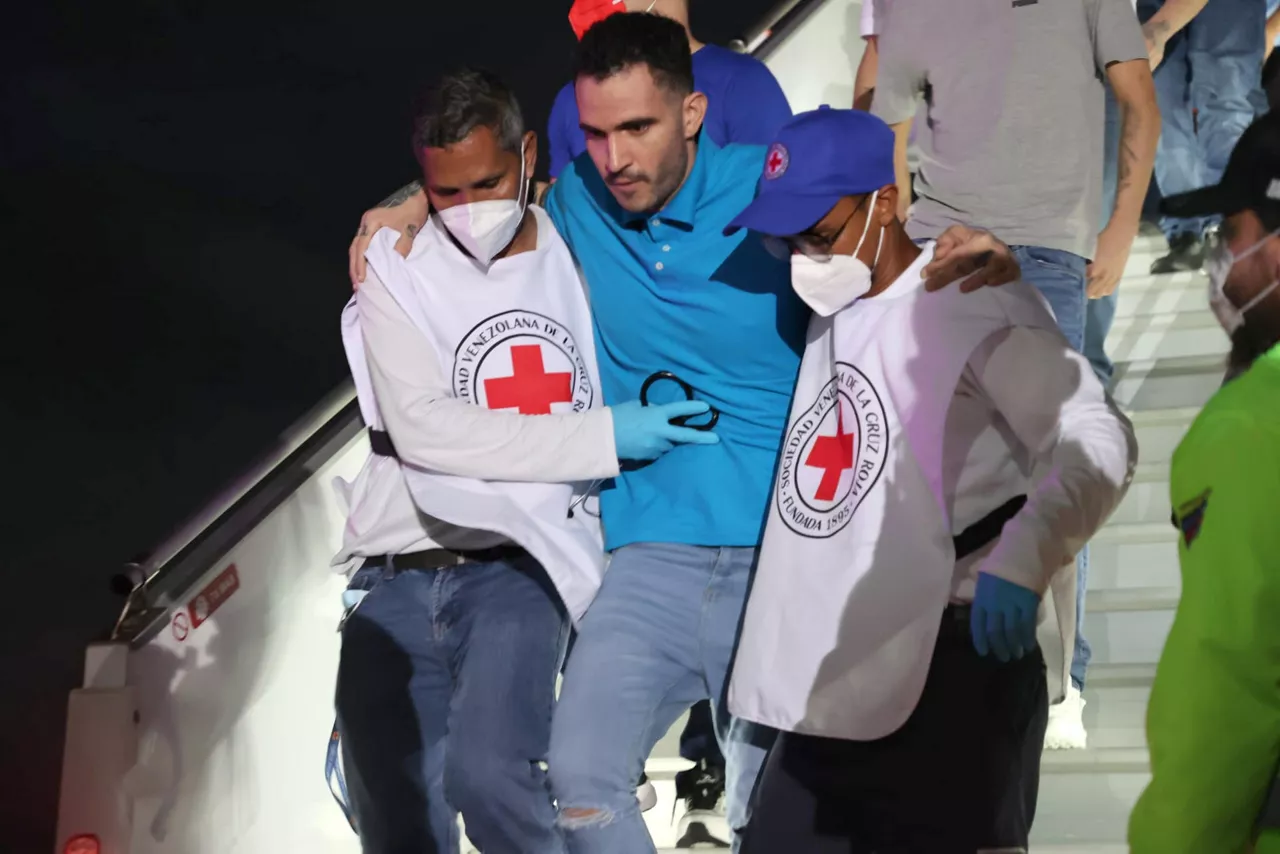 AME3830. MAIQUETÍA (VENEZUELA), 18/07/2025.- Fotografía cedida por el Ministerio del Poder Popular para Relaciones Interiores, Justicia y Paz de Venezuela, donde aparecen integrantes de la Cruz roja ayudando a un migrante deportado este viernes, en el Aeropuerto Internacional Simón Bolívar en Maiquetía (Venezuela). El presidente de Venezuela, Nicolás Maduro, anunció la llegada de migrantes deportados desde Estados Unidos hasta una cárcel de El Salvador, acusados de ser presuntos miembros de la banda transnacional Tren de Aragua. EFE/ Ministerio del Poder Popular para Relaciones Interiores Justicia y Paz /SOLO USO EDITORIAL/ NO VENTAS/ SOLO DISPONIBLE PARA ILUSTRAR LA NOTICIA QUE ACOMPAÑA (CRÉDITO OBLIGATORIO)
