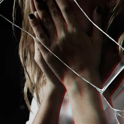 Depressed woman with cracked glass effect