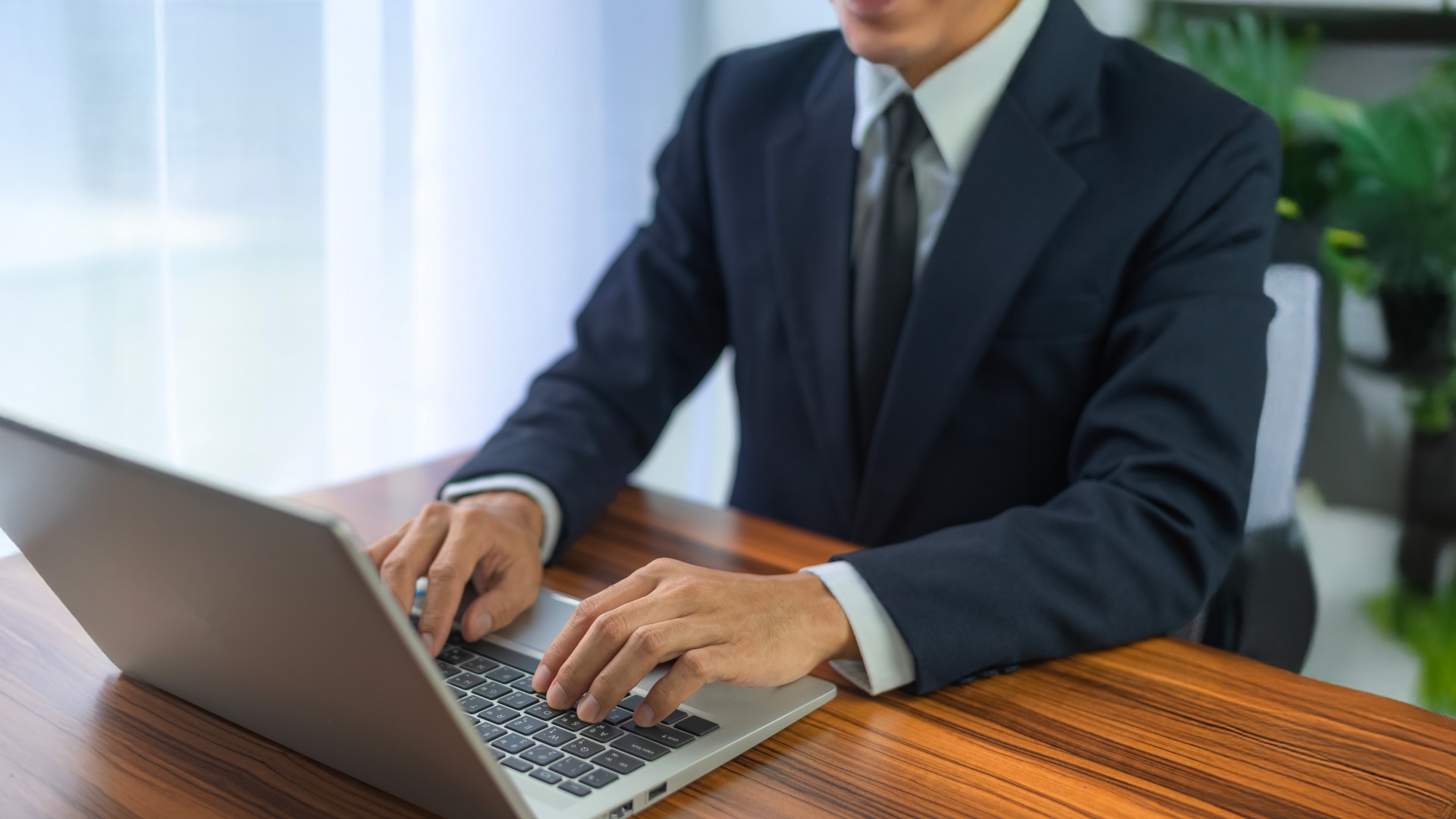 People using computer Side view of male hands typing on laptop keyboard