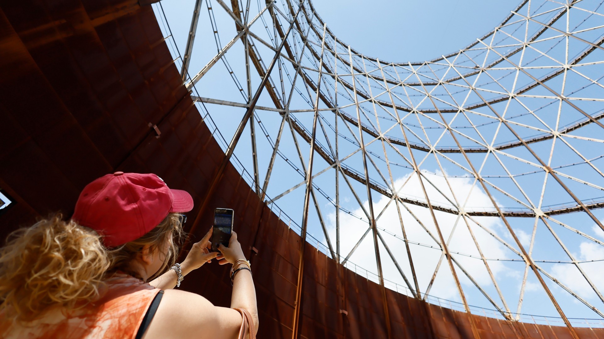 Woman photographing the Gazometro.