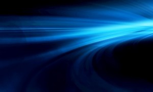 Abstract blue light trail on a dark background, with curved lines and gradients creating a sense of motion and speed.