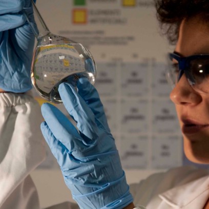 Scientist looks at test tube in lab