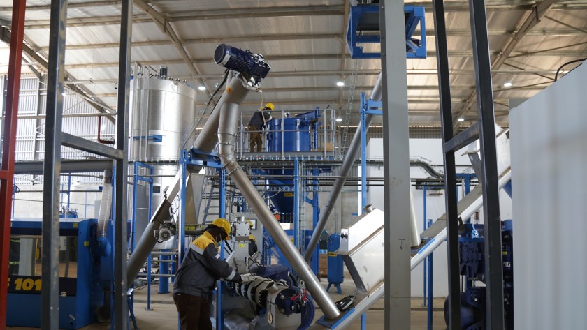 Africans workers in front of the vegetable raw materials processing plant”