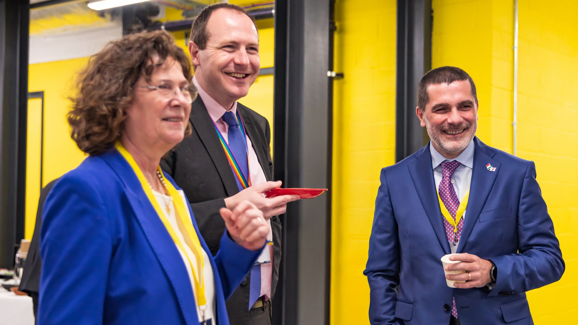 two men and a woman smile at the event announcing the partnership