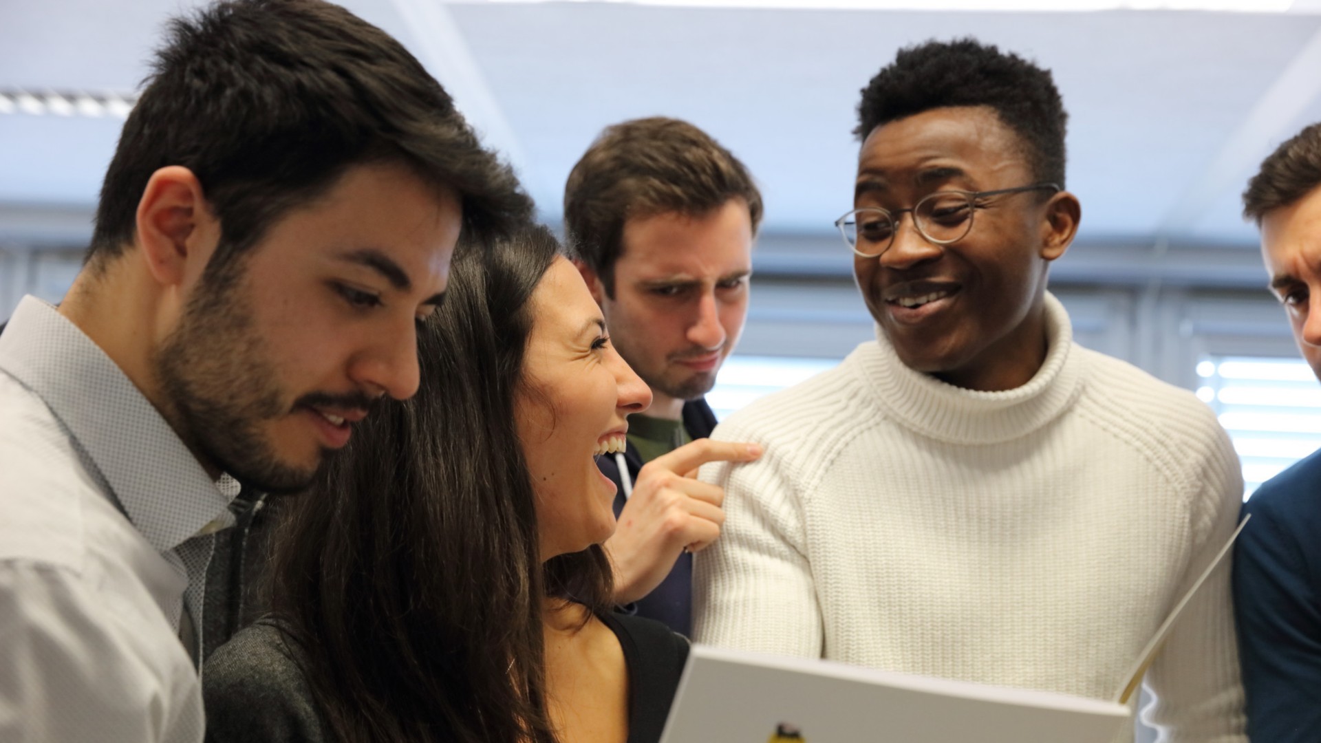 Five people talking and laughing