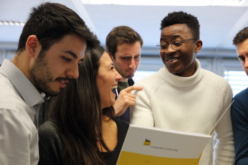 Five people talking and laughing