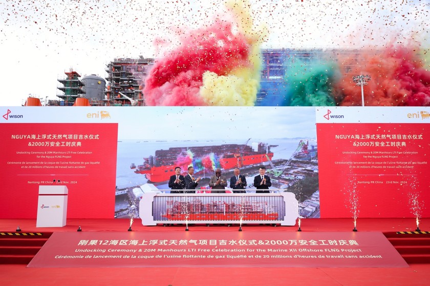 Rappresentanti alla cerimonia di sail away della (FLNG) Nguya applaudono sul palco