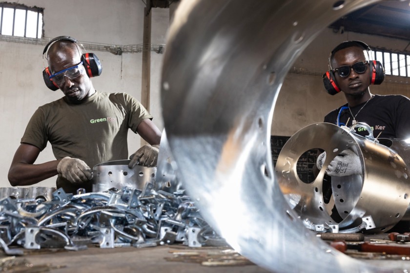 Two workers are working on the improved stoves 