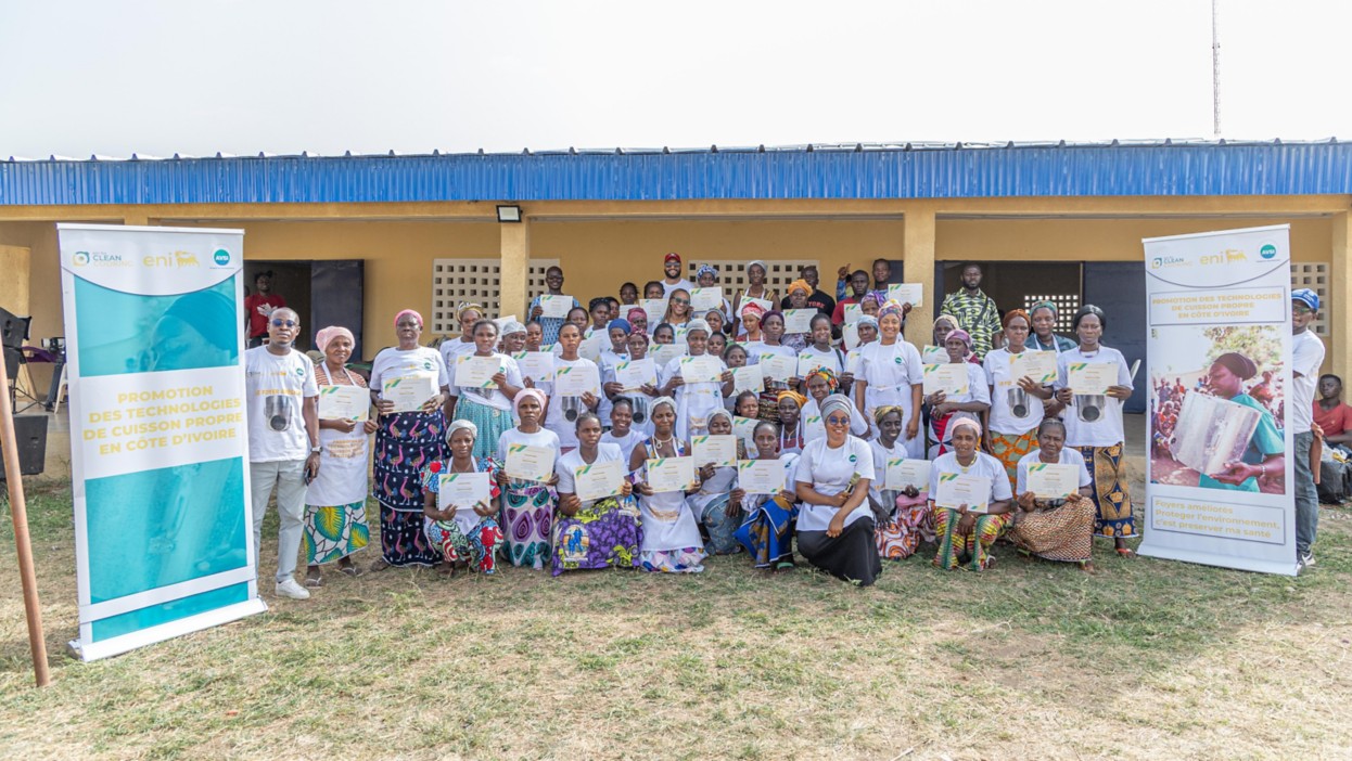 Group photo of women showing their certificates after a training course on improved stoves