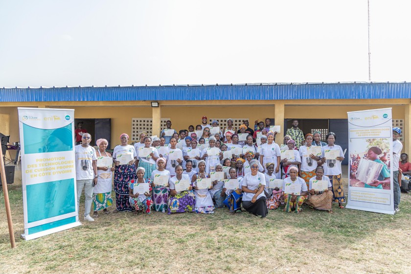 Group photo of women showing their certificates after a training course on improved stoves