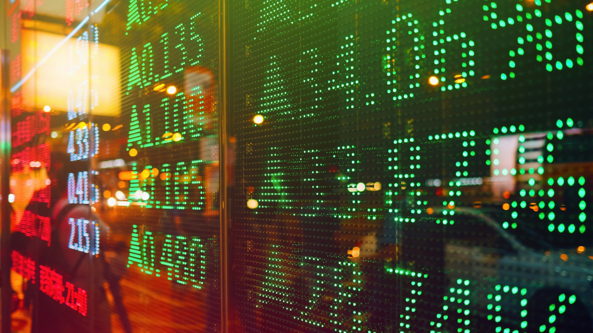 Stock exchange market display screen board on the street showing stock rises in green colour