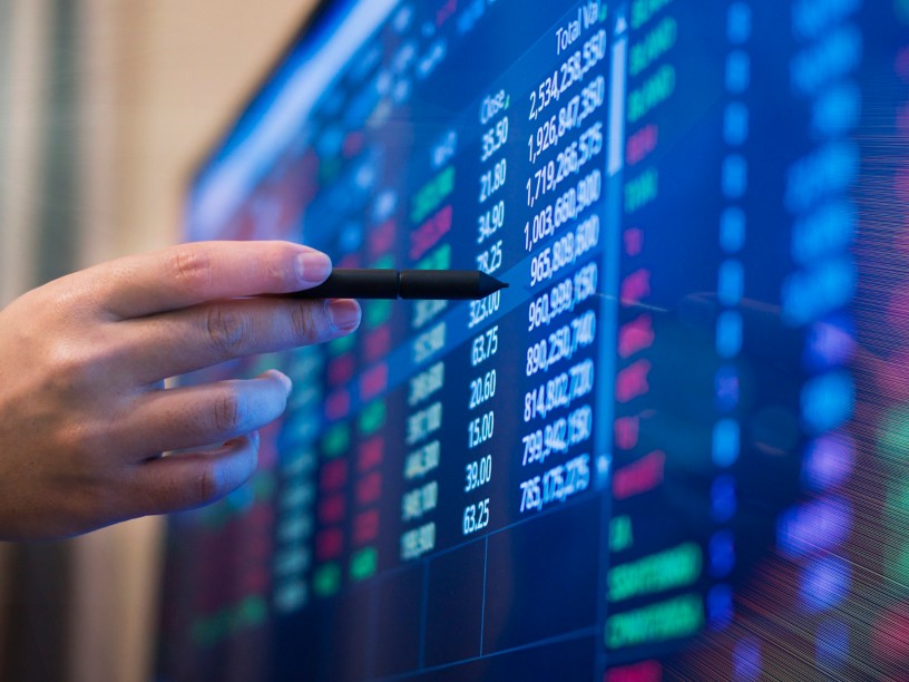 Hand pointing to financial data