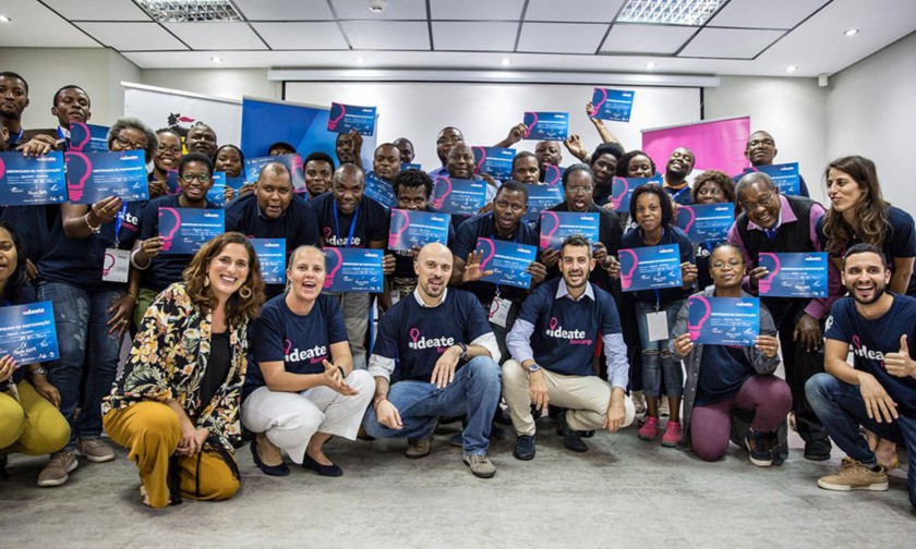 Group photo of the participants at the working table