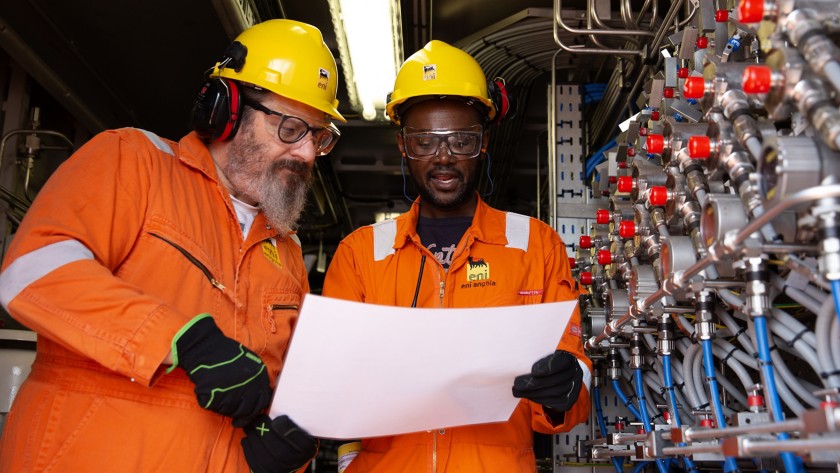 Two workers compare notes on the project