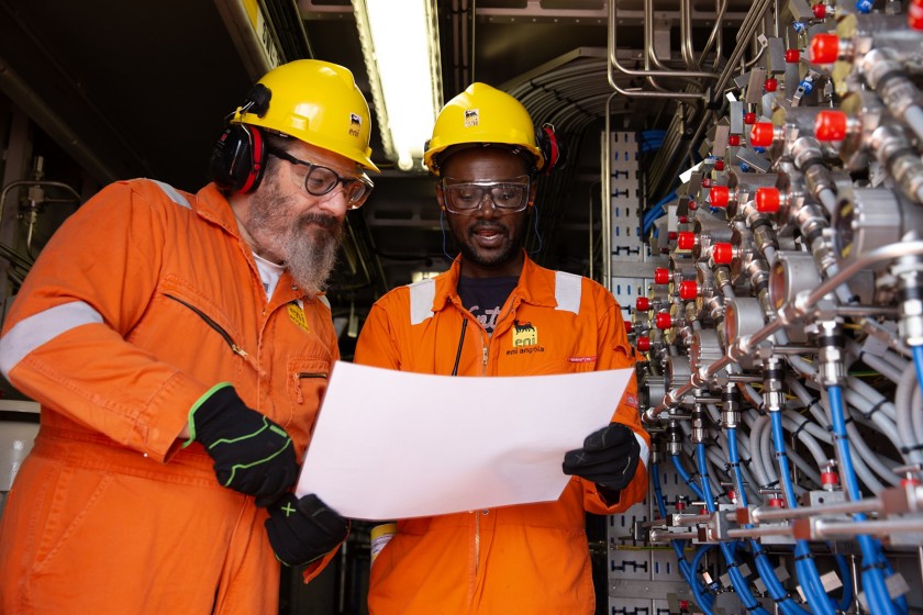 Two workers compare notes on the project