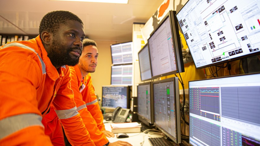 Group of workers looking at control panels