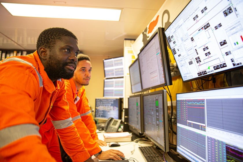 Group of workers looking at control panels