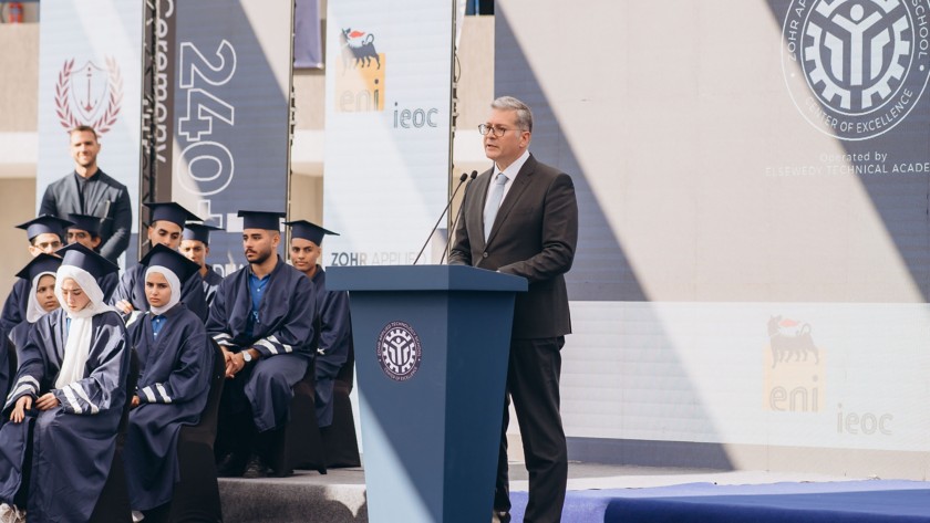 A man speaks into a microphone during a graduation day