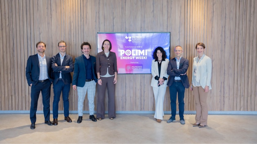 People standing in front of the Polimi energy week logo