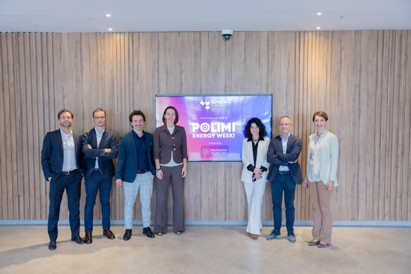 People standing in front of the Polimi energy week logo