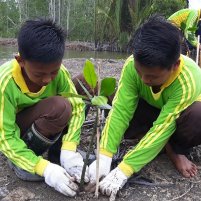 Asian kids planting a plant