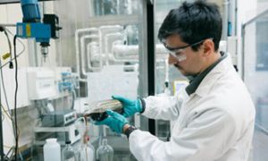 Scientist in lab analyzes liquid sample
