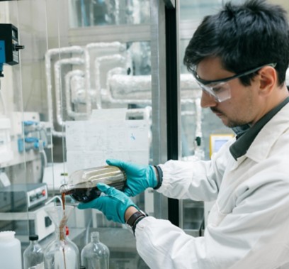 Scientist in lab analyzes liquid sample